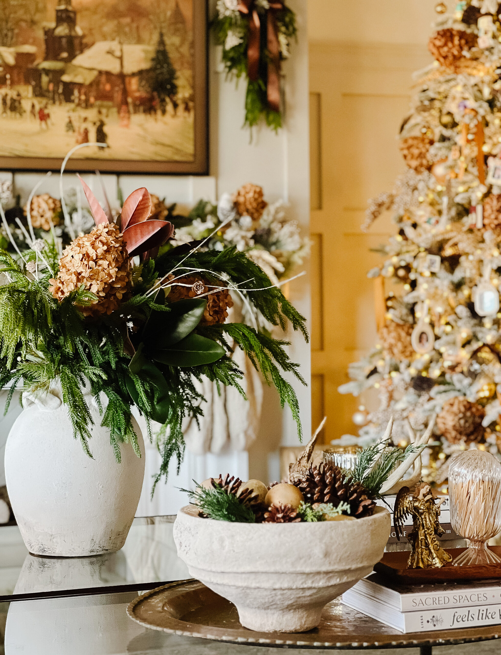 large vase with pine stems and dried hydrangeas, bowl with pinecones and ornaments